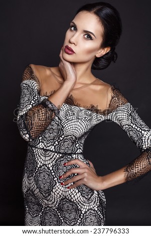 fashion studio photo of beautiful sensual woman with dark hair wearing luxurious lace dress