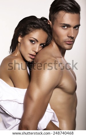 fashion photo of sexy impassioned couple posing in studio