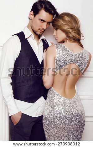 fashion studio photo of beautiful sensual couple in elegant clothes
