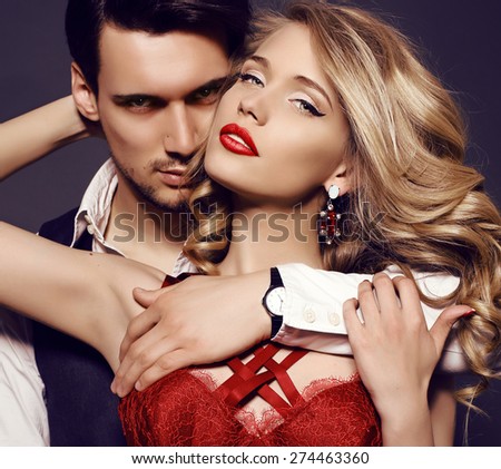 fashion studio photo of beautiful sensual couple in elegant clothes