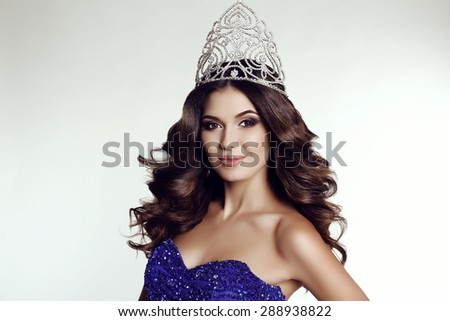 fashion studio photo of gorgeous winner of beauty contest wearing luxurious sequin dress and precious crown