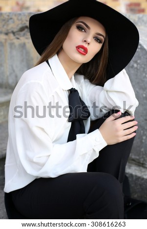 fashion outdoor photo of beautiful lady with dark hair wearing elegant clothes,posing in autumn park