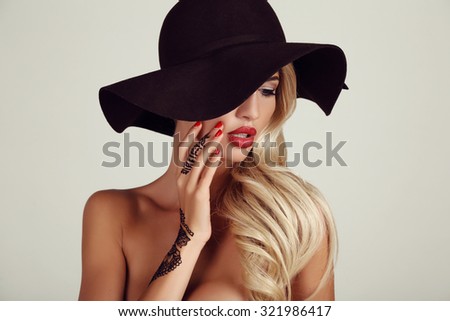 fashion studio photo of beautiful sensual girl with blond hair with henna pattern on hands
