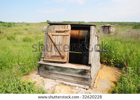 old Russian wooden draw well in the village