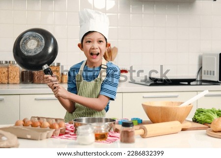Similar – Image, Stock Photo Smiling boy in apron in kitchen