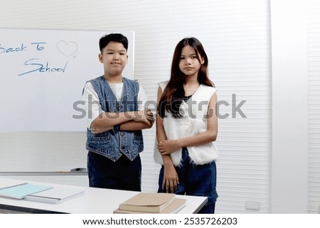 Similar – Image, Stock Photo Two schoolgirls spending time in school library. Primary school students learning from books. Children having fun in school club. Doing homework