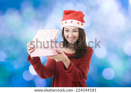 Christmas gift box opened from Asian Santa women