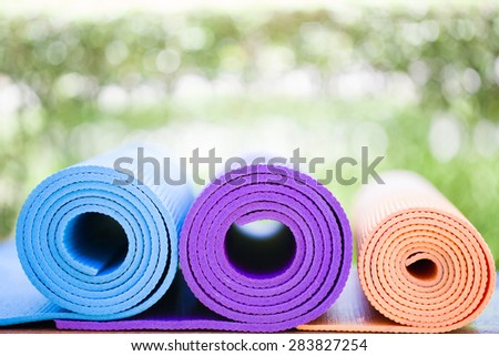 yoga mats on the table in a garden