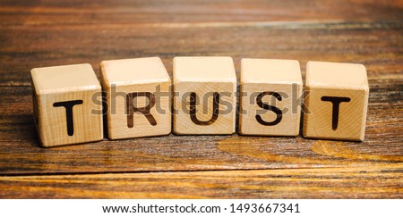Wooden blocks with the word Trust. Trust relationships between business partners, friends, relatives. Respect and authority. Confidence in a person. Reliable partner Foto d'archivio © 