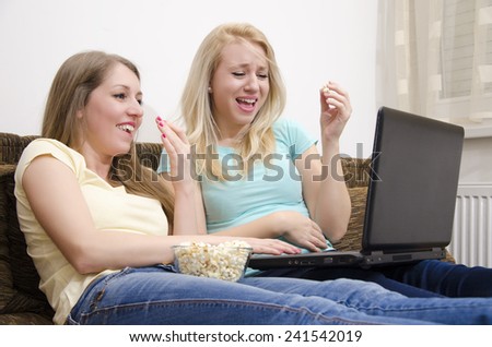 Girls laughing while looking at laptop screen/watching funny video clips