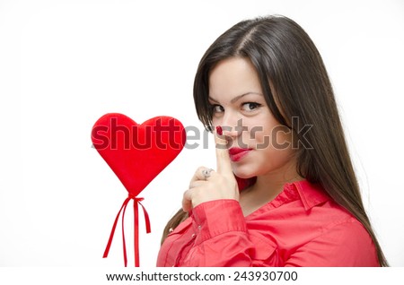 Cute girl holding finger on lips and heart wand, forbidden love, holding a secret. Cheating concept