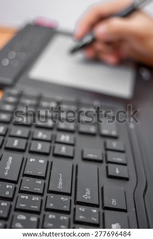close up view of graphic designer hand using digital tablet pen and computer in the office studio isolated on white background. Modern professional technology concept