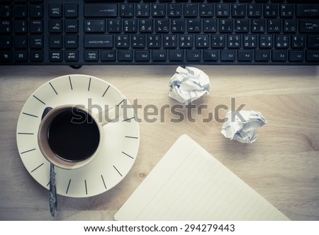 Office table with notepad, computer, coffee cup , computer mouse , pen, headphone. View from above with copy space