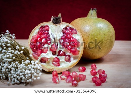 Pomegranate fruit. Pomegranates over Red Background