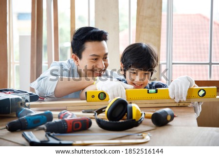 Similar – Image, Stock Photo Male woodworker teaching son in workshop