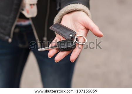 Transfer of car keys in female hands