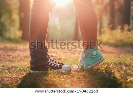 Young couple kissing in summer sun light. Kiss love standing