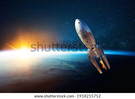 Metal vintage rocket with fire takes off into open starry space near the planet earth with sunset. Retro spacecraft lift off and flies on a background of the starry sky, planet and sunlight