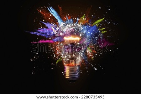 Electric light bulb exploding with paint and glass, a creative idea. Business and technology. Think different, concept. New thinking and brainstorming Imagine de stoc © 