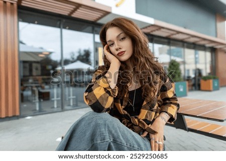 Similar – Image, Stock Photo Portrait of girl with her trendy sweater over her head having fun. Woman with tied hair, cold, hiding under her pink sweater. Fashion photo.