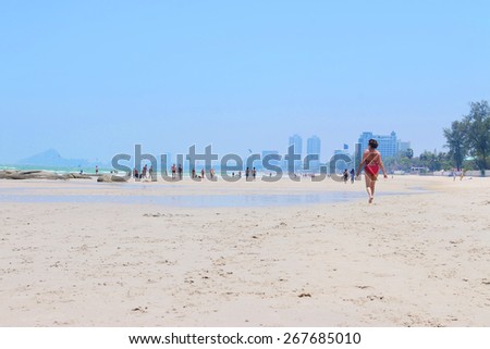 HUAHIN,THAILAND - April 2015 : View of the beach in HUAHIN, packed with people on a hot summer day on April 5 2015 in HUAHIN, THAILAND.