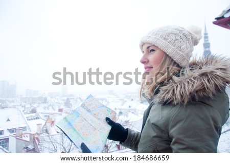 Portrait of young pretty tourist outdoors in winter