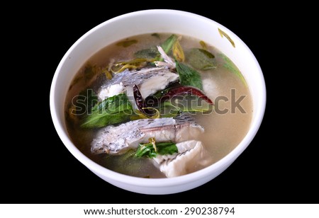 Delicious Fish soup for picnic ,Thai clear spicy hot & sour soup (Tomyum) with boiled asian  fish fillet and herb usually served in cup heated by a charcoal fire. selective focus