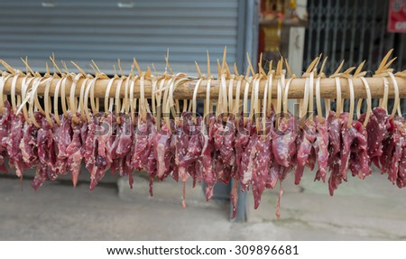 Dried meat on the wooden row.Portion of Beef Jerky on wooden row prepare for sale in the market of thailand. select some focus.