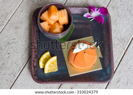Dessert - Mousse Cake with Orange Sauce Cantaloupe and orange fruit