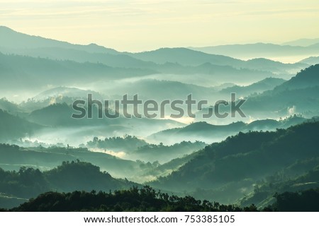 Photo of Beautiful Landscape of mountain layer in morning sun ray and winter fog at  Doi Hua Mae Kham,  Mae Salong Nai, Chiangrai, Thailand
