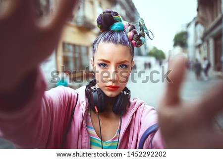 Cool funky young girl with headphones and crazy hair enjoy power of music taking selfie on street – hipster woman with trendy avant-garde look having fun - Music fan concept with playful carefree teen Zdjęcia stock © 
