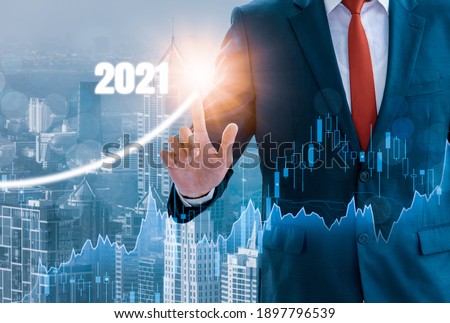 Businessman Growth success,using finger touch 2021,stock graph and chart background,concept growth development business investment,Stock market,strategy making market plan,stock market fluctuation