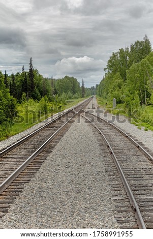 Image, Stock Photo Two railtracks become one in the alaskan wilderness. Concept of merging together