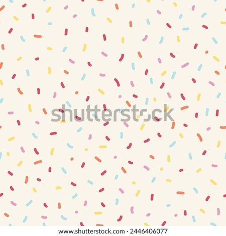 Seamless sprinkle pattern. Colorful background design with cute pastel colored sprinkles. 