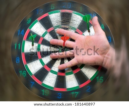 Human hand in the target darts