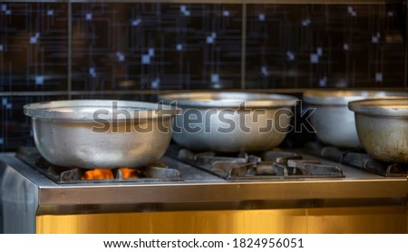 Cooking pots standing on the industrial stove Stok fotoğraf © 