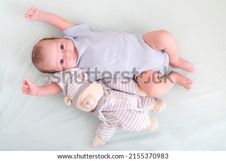 Similar – Image, Stock Photo 3 month old baby doing tummy time; bohemian interior room with houseplants