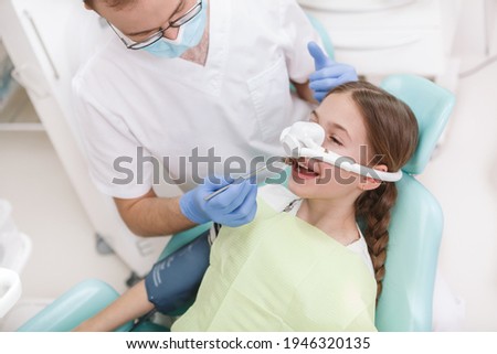 Young girl having her teeth treated while having inhalation sedation mask on Stock foto © 