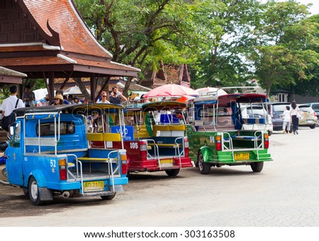 Ayutthaya Thailand - July 30 2015: Three Auto rickshaws, Motorized tricycles park to waiting travelers at Wat Chaiwatthanaram. Back view.