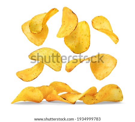 Flying crunchy potato chips over small pile isolated on white background.