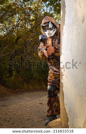 Paintball player with mask and his paintball gun