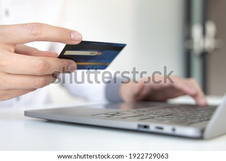 Online product purchase, Businessman use laptop register via credit cards to make online purchases, Shopping and mail, credit card online security, Online shopping concept.