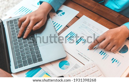 Financial businessmen use laptop to analyze marketing strategies and real estate data to reduce company taxes for their customers, Accounting and Tax concept.