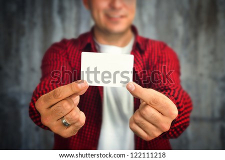 Construction worker holding a blank business card, business introduction concept.