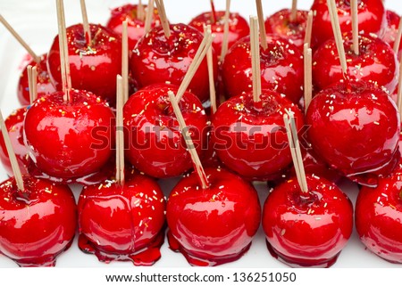 Beautiful tasty red candy apples on a table.
