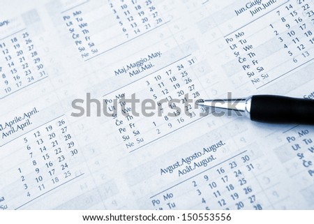 Ballpoint pen and agenda calendar, business background.