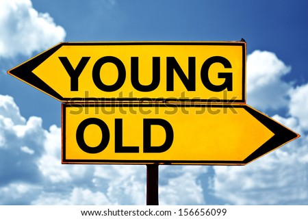 Young versus old, opposite signs. Two opposite signs against blue sky background.