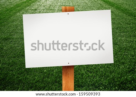 Blank sign on green lawn for your message.