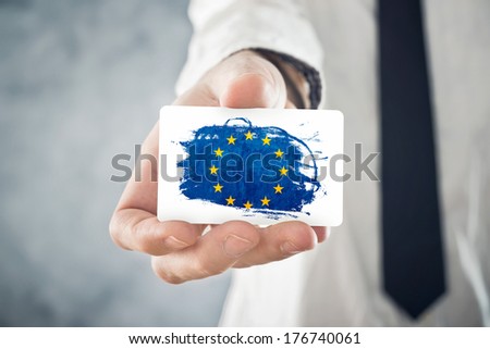 European Businessman holding business card with European union Flag. International cooperation, investments, business opportunities concept.