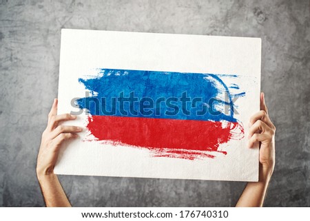 Russia flag. Man holding banner with Russian Flag. Supporting national team, patriotism concept.